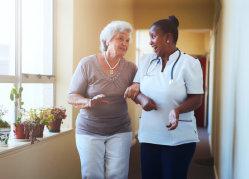 staff and elder woman talking