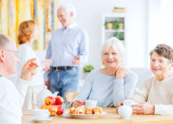 elderly people having a meal