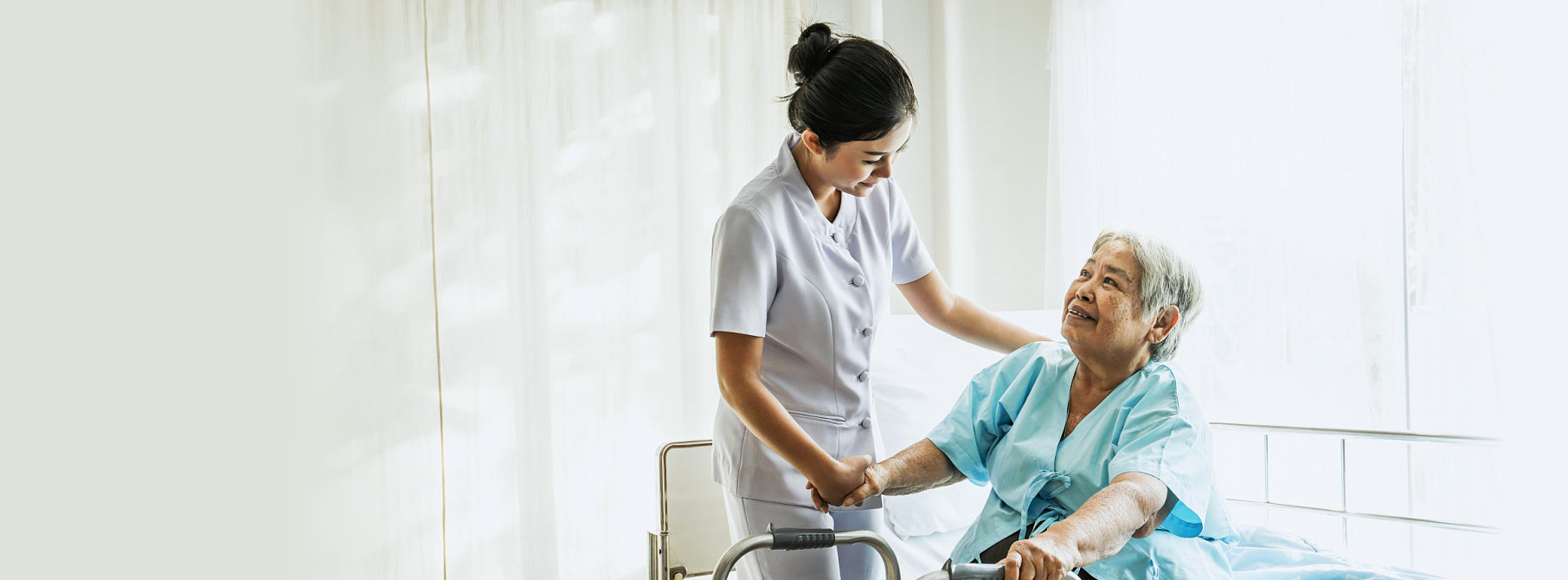 elder woman and staff smiling to each other