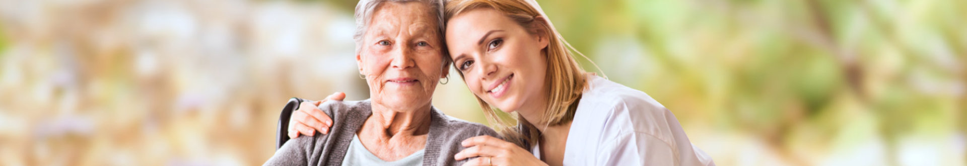 caregiver and elder woman smiling