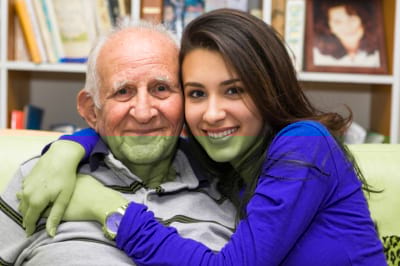 Elderly eighty plus year old man with granddaughter in a home setting